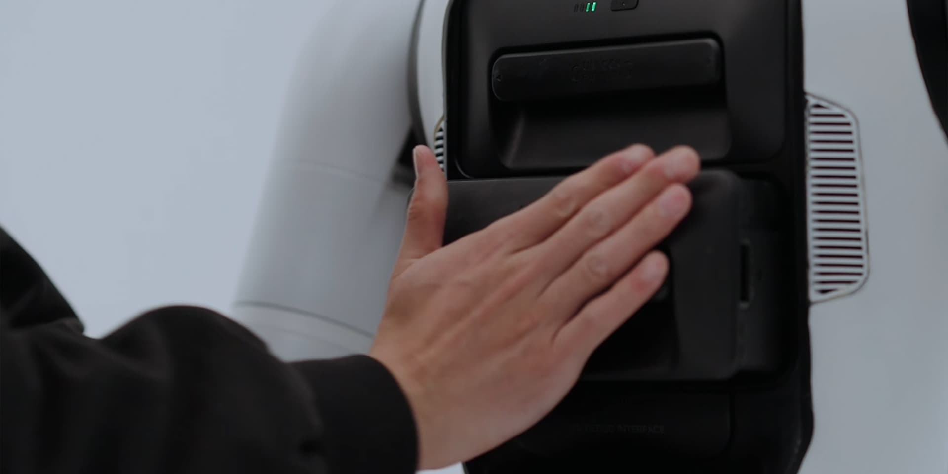 Operator accessing the battery interface on an AGIBOT A3 robot