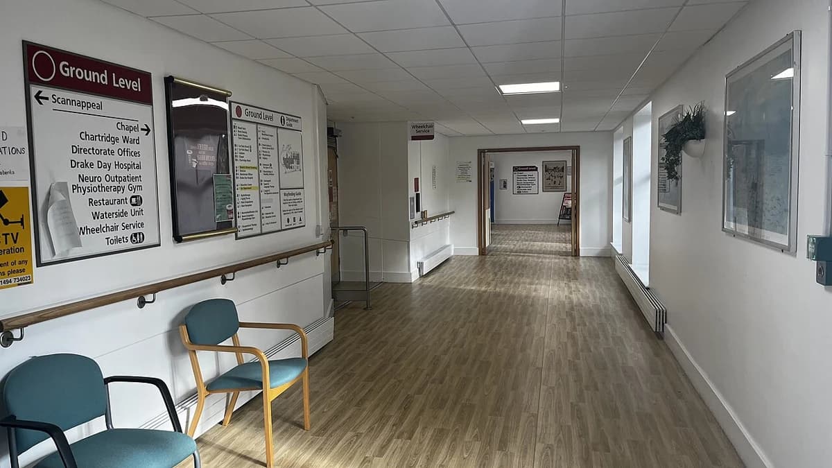 Hard-floor corridor with English wayfinding signs at Amersham Hospital, Buckinghamshire