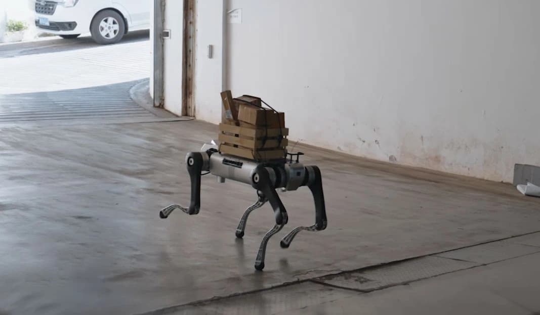 AGIBOT D1 MaxPro carrying strapped boxes through an industrial doorway, official manufacturer demonstration image